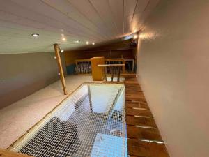 a house with a net on the floor of a room at La tiny house de Chaparon in Lathuile +2 photos