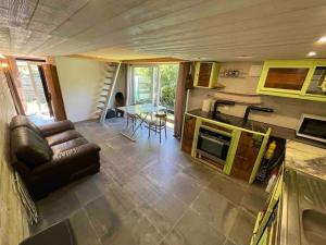 a living room with a couch and a table at La tiny house de Chaparon in Lathuile