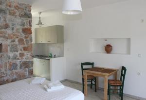 a room with a bed and a table with chairs at Dimitra Studios in Aegiali +22 photos