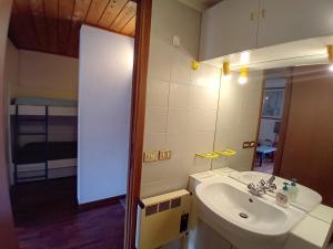 a bathroom with a sink and a mirror at La casa nel cuore di La Thuile in La Thuile