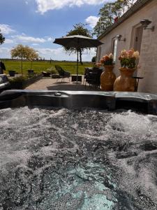 a large pool of water in front of a house at Munkgaard Bed & Breakfast in Rødvig