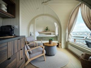 a bedroom with a bed and a table with a chair at Iglupark in Tallinn