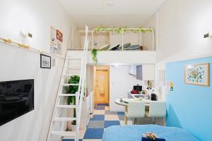 a room with a bunk bed and a table and chairs at SC Heights 106 in Tokyo