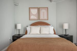 a bedroom with a large bed with two lamps at Brookline 2br w public wd nr Fenway groceries BOS-909 in Brookline