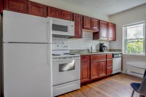 a kitchen with a white refrigerator and wooden cabinets at South Boston 1br w building wd nr seaport BOS-913 in Boston
