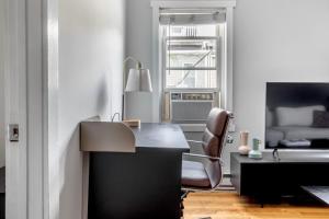 an office with a desk and a chair and a bed at South Boston 2br w building wd nr seaport BOS-914 in Boston