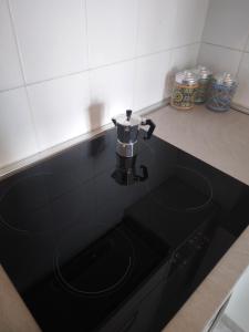 a black counter top with a coffee pot on it at Spazioso appartamento Parabiago in Parabiago