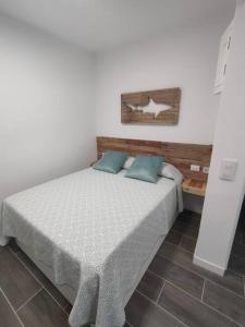 a bedroom with a large bed with blue pillows at Casa Paula in Las Playitas