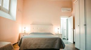 a bedroom with a bed and two night stands at Domus Antica in Santa Maria Capua Vetere