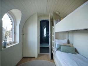 a bedroom with a bed in a room with a window at Iglupark in Tallinn