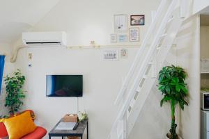 a white staircase in a living room with a couch at SC Heights 203 in Tokyo