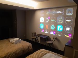 a room with a wall with a large display of apps at MERBABU STAY OSAKA in Osaka
