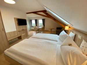 a hotel room with two beds and a table at Gasthof Drei Schwanen in Langenwetzendorf