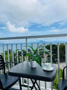 a table with two cups and a plant on a balcony at Tagaytay Staycation in Tagaytay