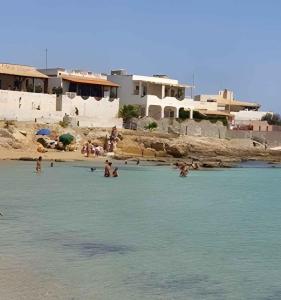 a group of people in the water at a beach at Holiday home in Portopalo 35405 in Portopalo