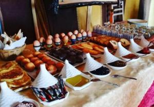 a table with eggs and other food on it at Sahara traveling camp in Merzouga