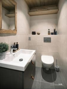 a bathroom with a white sink and a toilet at Beautiful apartment - high standard - Geilo centre in Geilo