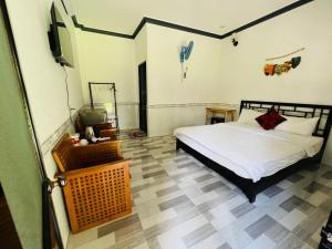 a bedroom with a bed and a television in it at Sky Home in Ấp Khánh Phước (1)