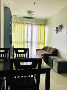 a living room with a table and a couch at Primavera Residence Silver 3Kates in Cagayan de Oro