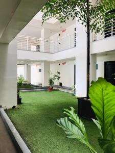 a courtyard with a green lawn in a building at Primavera Residence Silver 3Kates in Cagayan de Oro