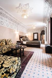a living room with a couch and a table at Riad Dar Laura in Fez