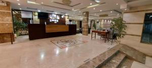 eine Lobby mit einem Schreibtisch und einem Tisch in der Unterkunft Sea Club Resort in Dammam