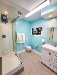 a bathroom with a shower and a toilet and a sink at Luxury Beach-Front High-Rise Apartment in San Diego