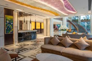 a lobby with couches and a bar in a building at Wyndham Garden Hanoi in Hanoi