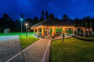 a gazebo with a playground in a park at night at Parzenica B&B in Białka Tatrzańska