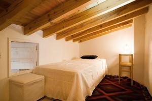 a bedroom with a bed in a room with wooden ceilings at Modus Vivendi Holidays Arsos in Arsos