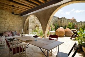 a patio with a table and chairs and a castle at Modus Vivendi Holidays Arsos in Arsos