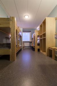 a large room with bunk beds and a large window at STF Abisko Turiststation in Abisko
