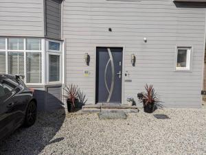 a house with a door and a car parked in front of it at Apartment in Bournemouth, Dorset in Bournemouth