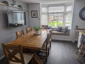a dining room with a table and chairs and a couch at Apartment in Bournemouth, Dorset in Bournemouth