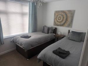 a bedroom with two twin beds and a window at Apartment in Bournemouth, Dorset in Bournemouth