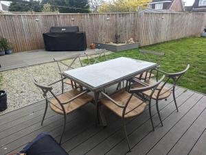 a table and chairs on a wooden deck at Apartment in Bournemouth, Dorset in Bournemouth