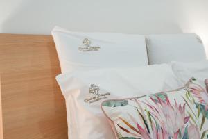 a white bed with three pillows on it at Casa da Petisqueira 61 - Paredes-Oporto in Rebordosa +36 photos
