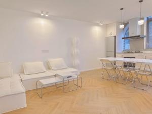 a white living room with a white couch and a table at ZHome-Three floors 4 bedrooms - near Nanjing Road in Shanghai