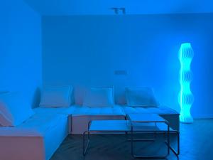 a living room with a couch and a blue light at ZHome-Three floors 4 bedrooms - near Nanjing Road in Shanghai