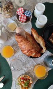 a table with bread and other food on it at Le Manoir de la Beslière - Gîte et Chambres d'hôtes in Folligny +13 photos