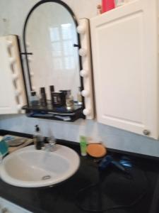 a bathroom with a sink and a mirror at Mar de flores in Vega de San Mateo