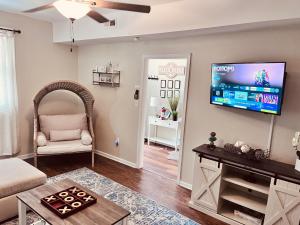 a living room with a flat screen tv on the wall at 3 bedroom comfy RVA in Richmond
