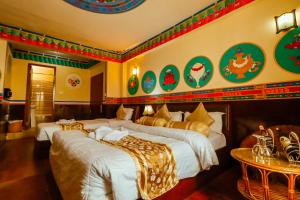 a hotel room with two beds and a table at Kathmandu Eco Hotel in Kathmandu