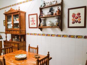 a dining room with a wooden table and a cabinet at La Casa de Manolo in Cazalla de la Sierra