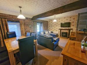a living room with a couch and a table at Highcroft & Windale @ Wetheral Cottages in Great Salkeld