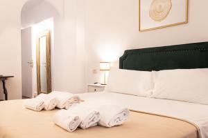 a bedroom with a bed with towels on it at Charme & Chic San Giacomo in Rome