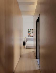 a hallway leading to a bedroom with a bed at Architect’s home pad - Valletta in Valletta