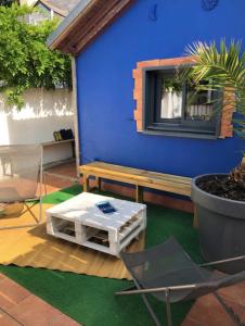 a patio with a bench and a table at Charming House In Pornichet Near The Beach in Pornichet