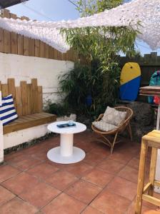 a patio with a bench and a table and a chair at Charming House In Pornichet Near The Beach in Pornichet
