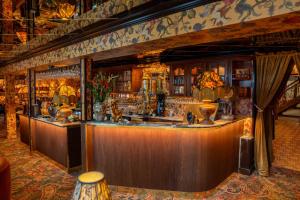 a bar with a counter in a room at Charmante Skostredet Hôtel in Bergen +78 photos